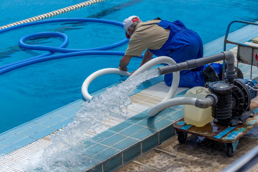 stock-photo-cleaning-the-sports-pool-with-a-cleaning-water-pump-the-water-pump-filters-the-water-from-the-1179453976-e1652841126542