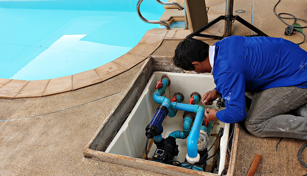 a person working in a pool maintenance